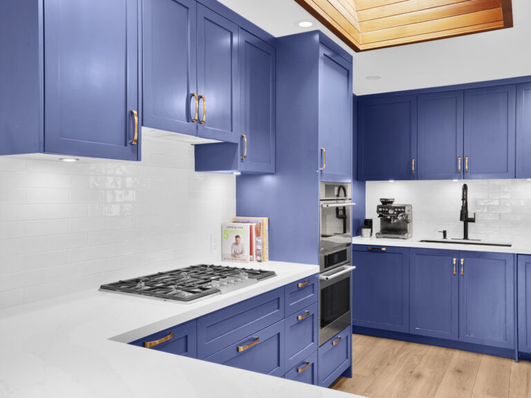 Open-concept kitchen with island and custom cabinets at 614 Elstree Pl North Vancouver